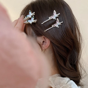 Nahaufnahme der süßen Acryl-Schmetterlings-Haarspange mit Perlen am Haar des Models