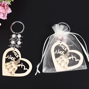 Heart-shaped wooden keychain with girl print and pearls in an organza gift bag
