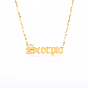 Macro detail of golden Scorpio gothic pendant on a fine stainless steel chain