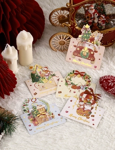 Detailed view of assorted Christmas cards with gold foil lettering and festive elements