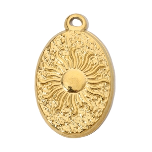 Macro shot of oval golden sun pendant with fine relief texture on white background