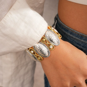 Detail of vintage stretch bracelet featuring silver hammered metal and gold rope edges