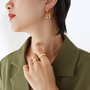 Exaggerated chunky gold necklace with zircon lock pendant and textured rings for women