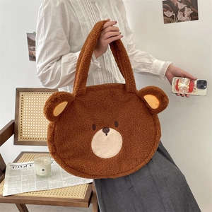 Detail of cute brown teddy fleece bear tote bag shown in a cozy lifestyle setting