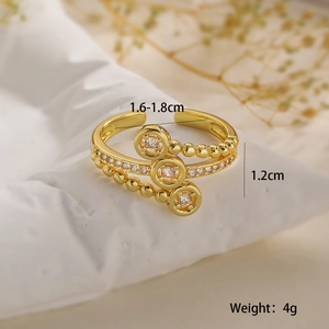 Macro shot of gold-plated beaded ring with sparkling zircons and size measurements