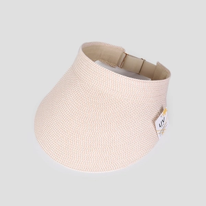 Detail of beige woven sun visor with wide brim and adjustable buckle showing UV care tag