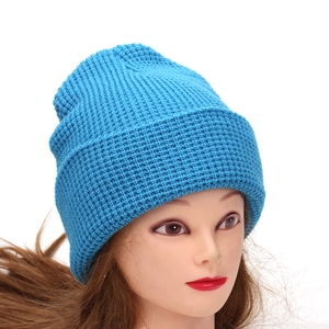 Sky blue waffle knit beanie hat with cuffed design for winter warmth on a display head