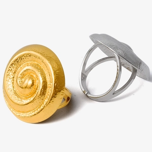 Macro detail showing spiral texture and matte finish on gold and silver stainless steel rings