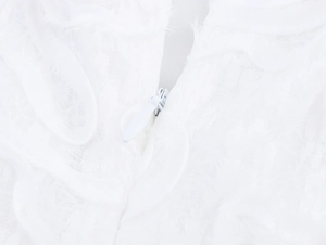 Dettaglio del vestito bianco con cerniera invisibile e tessuto floreale con texture 3D