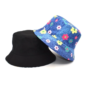 Women's reversible bucket hat featuring black fabric and colorful floral daisy prints