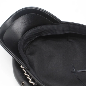 Detail of black PU leather baker boy hat showing inner lining and silver metal chain