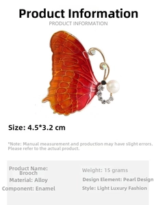 Detail view of enamel butterfly brooch with dimensions 4.5 by 3.2cm and weight 15g