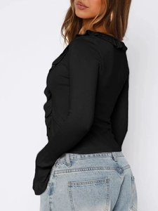 Detail view of black Y2K long sleeve top featuring ruffle accents and side fit on a model