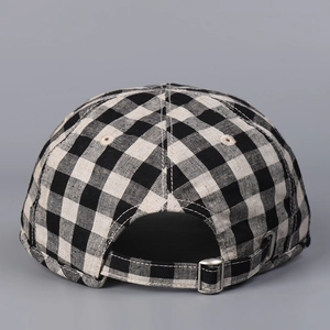 Detail of checkered linen baseball cap back with adjustable silver metal buckle strap