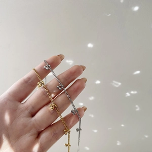 Detail of dainty gold and silver cherry pendant necklaces with minimalist chain links