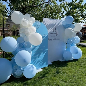 Outdoor blue and white macaron balloon arch with custom birthday backdrop on green lawn
