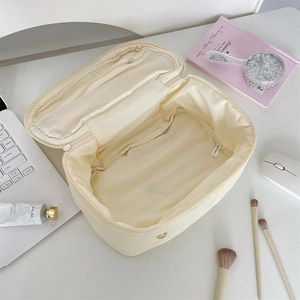 Spacious beige quilted rabbit makeup bag with inner zipper mesh pocket and large main compartment