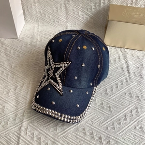 Detail of dark blue denim baseball cap with rhinestone star and pearl embellishments