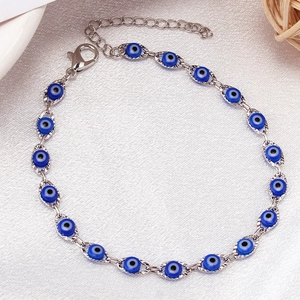 Silver chain bracelet featuring blue evil eye charms with lobster clasp and extender link
