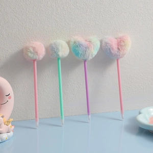 Detail view of rainbow gradient plush pom-pom pens in heart and round shapes