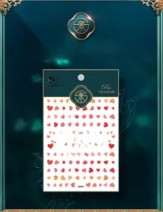 Close-up of red heart pattern nail stickers KX097 in luxury green gold packaging