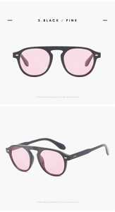 Detail view of retro sunglasses with black thick frames and light pink translucent lenses