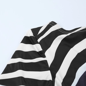 Detailed close-up of the black and white striped dress neckline with fine stitching