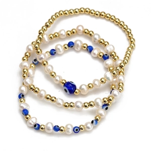 Detailed view of 3-piece blue evil eye beaded bracelet set with gold beads and white pearls