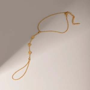 Detail of 18k gold plated stainless steel ring bracelet with circular sequin charms