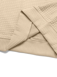Close-up of khaki waffle knit fabric and ribbed cuff stitching on men's casual pullover