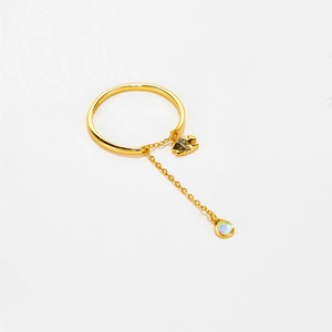 Close-up of S925 sterling silver gold ring featuring a bird charm and pearl chain drop