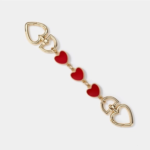 Golden heart extension chain for bags featuring three vibrant red heart charms on white