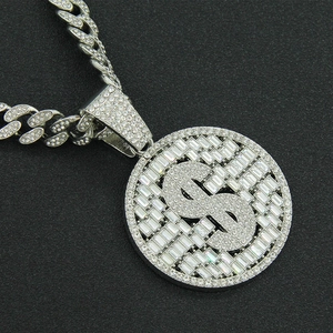 Silver iced out Cuban link necklace with sparkling dollar sign medallion on black background
