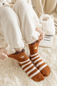 Detail of coral fleece striped socks with cute bear pattern for winter warmth