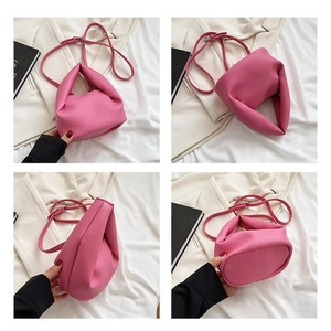 Detailed views of a pink lychee grain leather bucket bag with top handle and strap