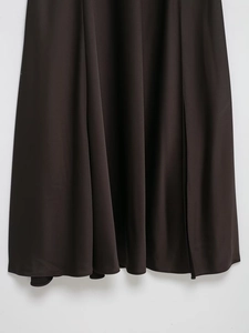 Detailed view of the dark satin maxi dress fabric showing elegant drape and smooth texture