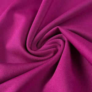 Gros plan du tissu en maille magenta montrant sa texture douce et ses détails élastiques