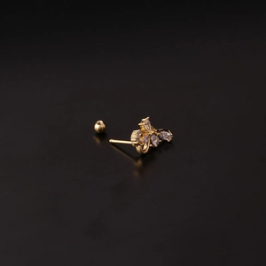 Golden bow stud earring with sparkling cubic zirconia stones and screw ball back