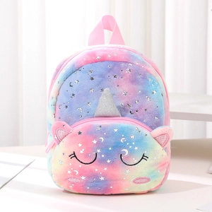 Detail of plush unicorn backpack featuring tie-dye fabric and silver moon-star patterns
