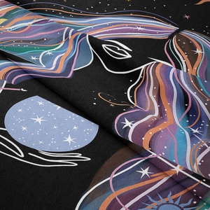Close-up of bohemian tapestry fabric showing celestial moon and sun print details