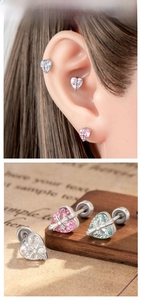 Detailed view of heart-shaped cross earrings in clear pink and blue zirconia