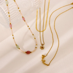 Layered beaded butterfly necklace with gold sun and flower pendants in pastel colors