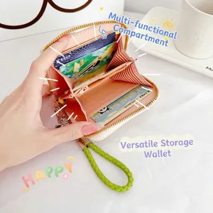 Coral pink cartoon cat wallet with multi-card slots and green wrist strap shown open