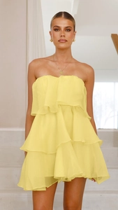 Front view of bright yellow strapless tiered cake dress with layered chiffon ruffles