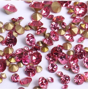 Macro shot of sparkling pink and gold multifaceted rhinestones for DIY nail art decoration
