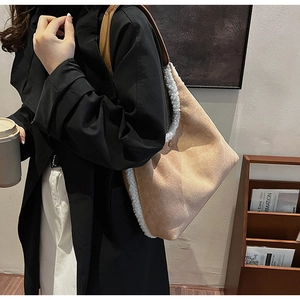 Detail view of beige plush tote bag with brown leather strap and soft white faux fur trim