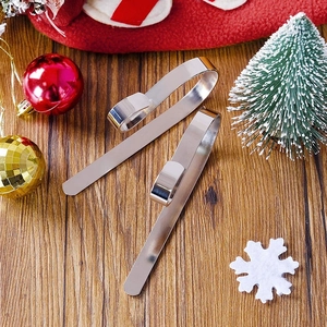 Set of two silver Christmas stocking hooks for mantel decoration with festive ornaments