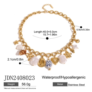 Gold stainless steel ocean necklace with shell charms and blue tulip ceramic bead