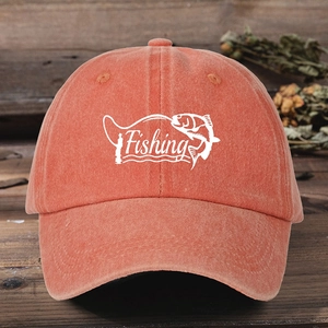 Close-up of orange washed cotton baseball cap with Fishing embroidery on wood