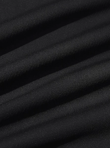Macro shot of high-density black corduroy fabric texture and woven detail on male shirt